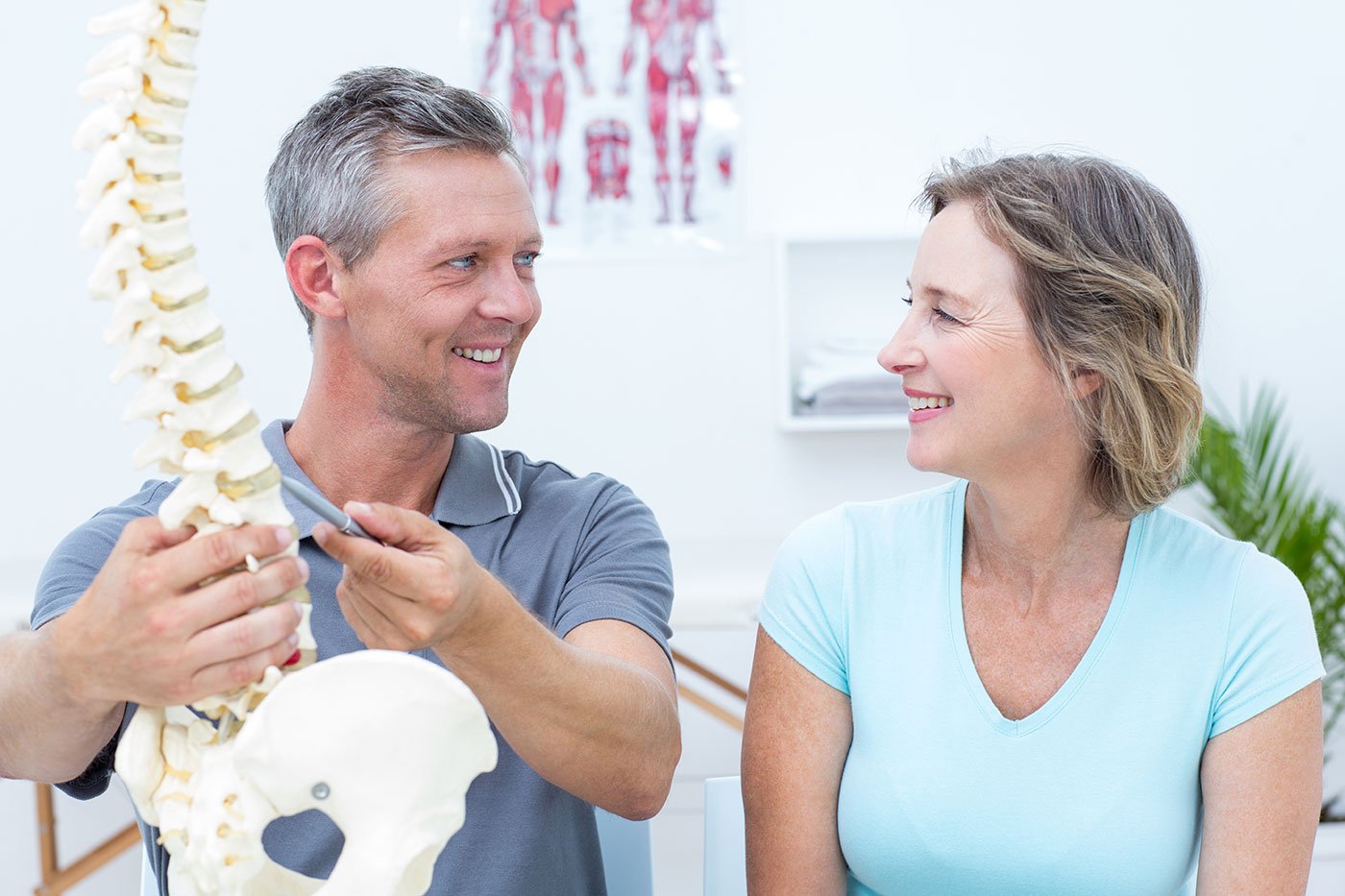Routine chiropractic care, chiropractic consultation between male Dr. and female patient